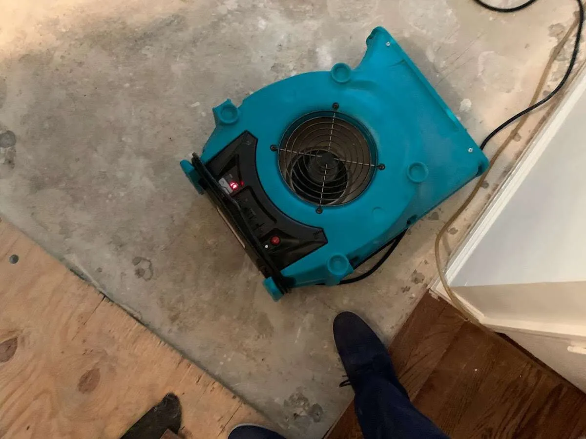 Air mover drying subfloor during Leak Detection & Repair in Houston